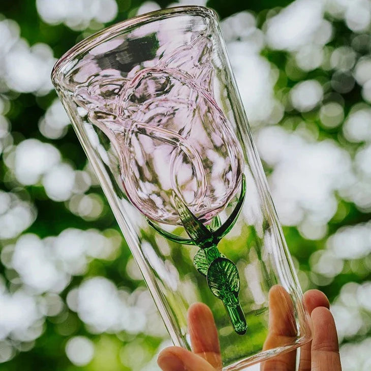 Handcrafted rose glass with intricate blossom details on a dining table