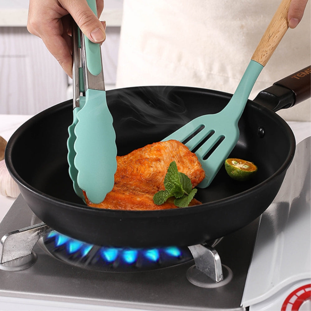 Non-stick kitchenware set displayed on a modern kitchen countertop.