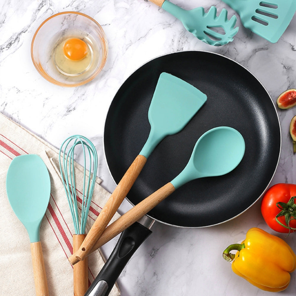 Non-stick kitchenware set displayed on a modern kitchen countertop.