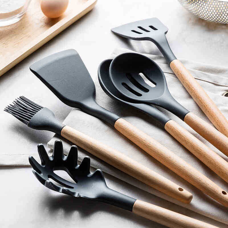 Non-stick kitchenware set displayed on a modern kitchen countertop.