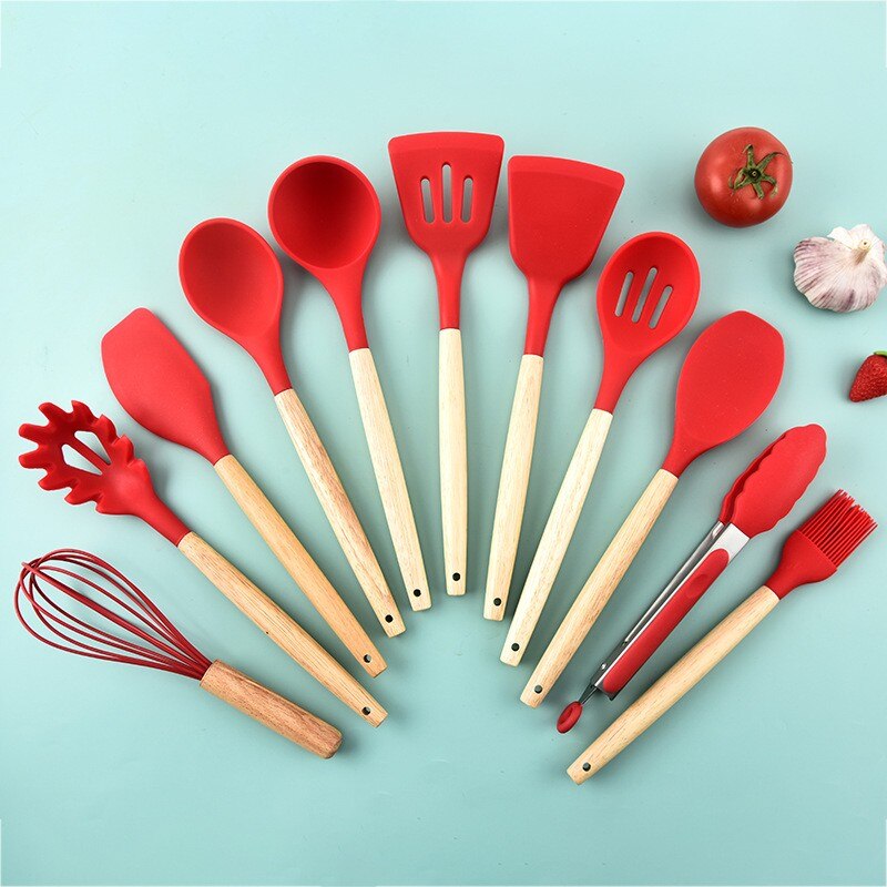 Non-stick kitchenware set displayed on a modern kitchen countertop.