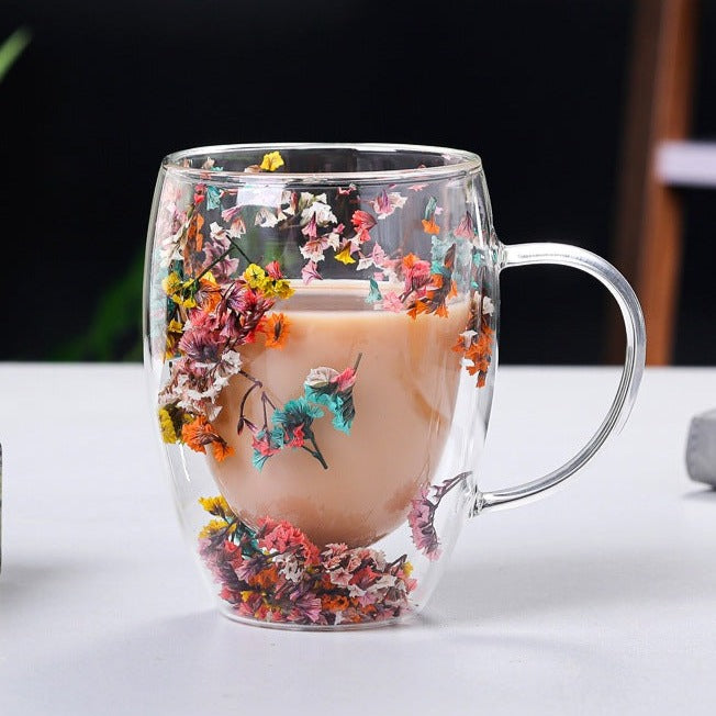 Elegant glass mugs with floral motifs on a coffee table.
