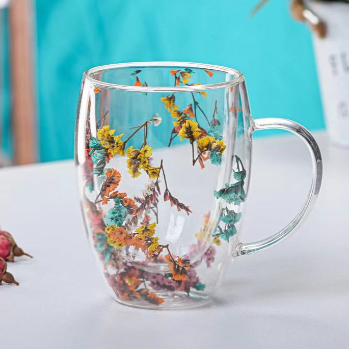 Elegant glass mugs with floral motifs on a coffee table.
