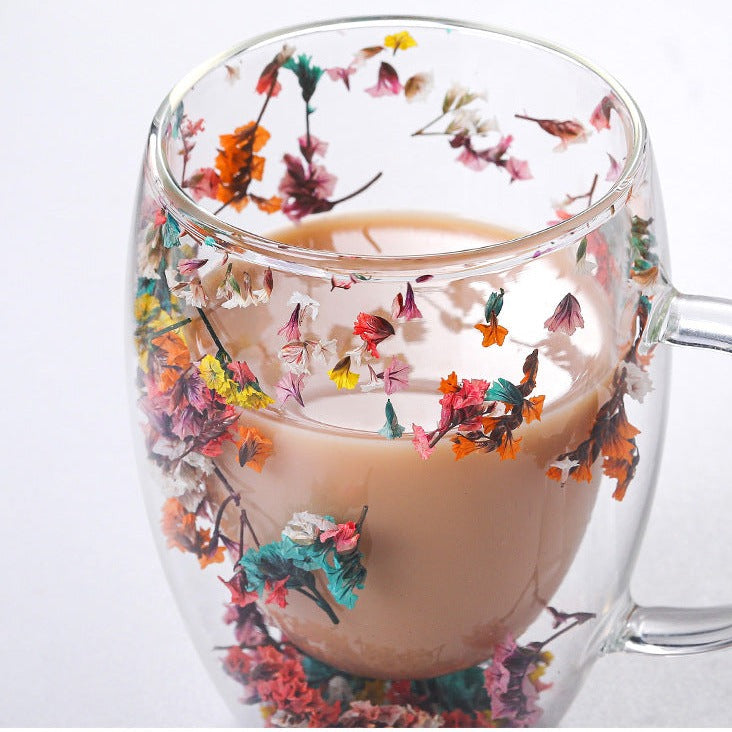 Elegant glass mugs with floral motifs on a coffee table.
