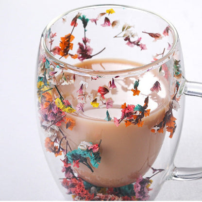 Elegant glass mugs with floral motifs on a coffee table.
