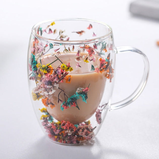 Elegant glass mugs with floral motifs on a coffee table.

