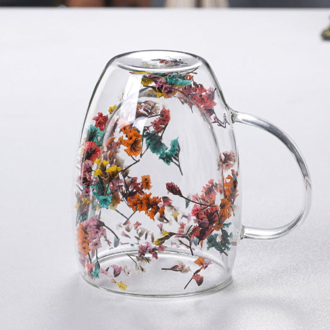 Elegant glass mugs with floral motifs on a coffee table.
